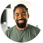 Jamal is a black man and is smiling and wearing a green tee shirt.