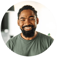 Jamal is a black man and is smiling and wearing a green tee shirt.