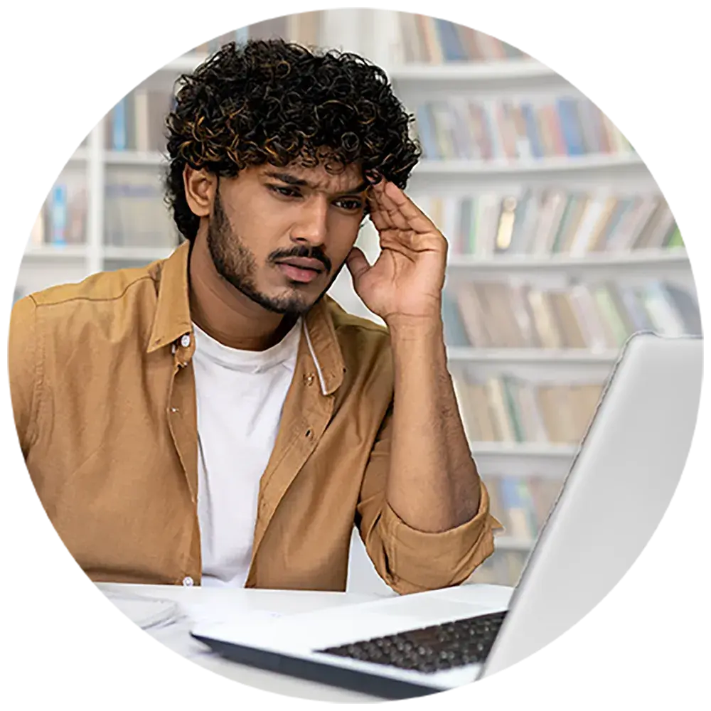 An hispanic male reader at a laptop who is struggling to read. An hispanic male reader at a laptop who is struggling to read.